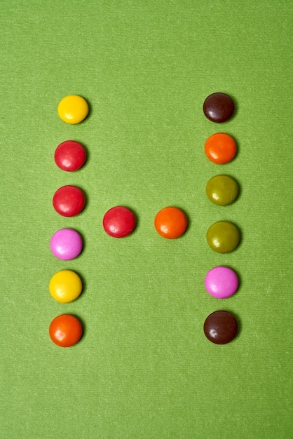 A screenshot showing the strategic creation and use of a vertical striped candy in Candy Crush Saga level 27. The candy is about to be activated to clear a column of chocolate and other candies.