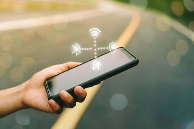 A hand holding up a smartphone, with a Wi-Fi analyzer app showing various Wi-Fi networks and their signal strengths.